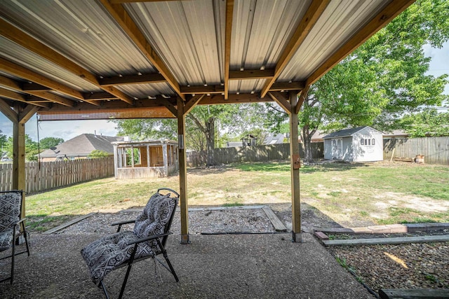 view of patio featuring a fenced backyard, an outdoor structure, and a storage shed