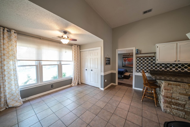 tiled dining space with ceiling fan, baseboards, and visible vents