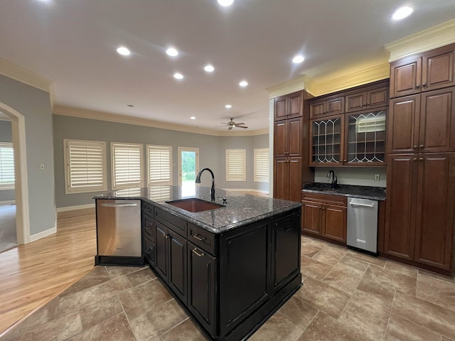 kitchen with a sink, crown molding, stainless steel dishwasher, and an island with sink