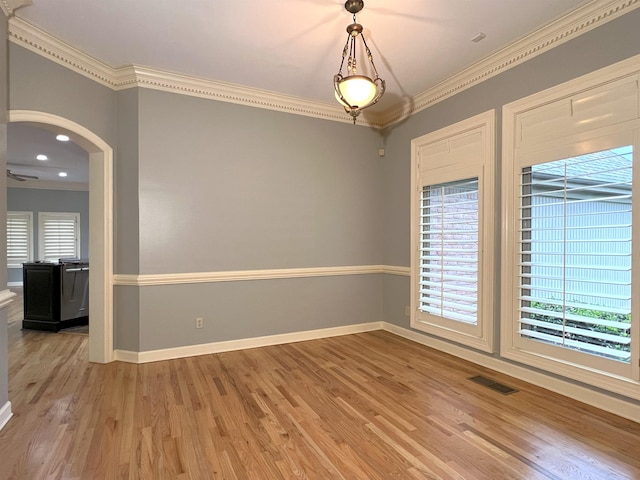 unfurnished room featuring crown molding, visible vents, and light wood-style floors
