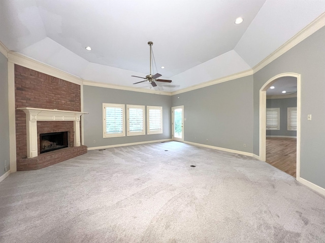 unfurnished living room featuring baseboards, a ceiling fan, carpet flooring, and ornamental molding