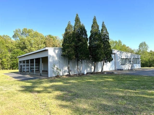 exterior space with an outbuilding, an outdoor structure, and a yard