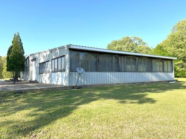 view of outbuilding with a sunroom