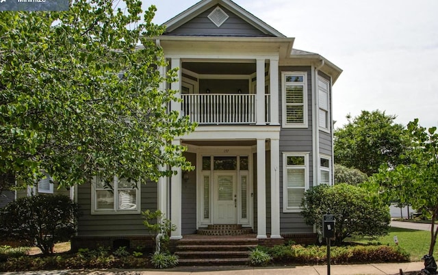 neoclassical / greek revival house featuring a balcony