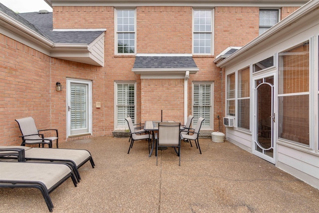 view of patio with cooling unit and outdoor dining space