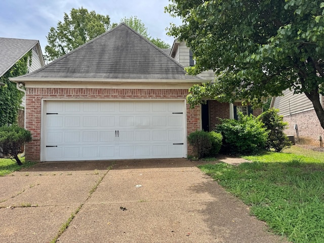 view of front of property featuring an attached garage, brick siding, roof with shingles, and driveway