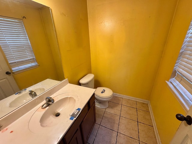 bathroom featuring tile patterned floors, baseboards, vanity, and toilet