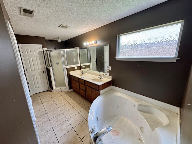 full bathroom with a textured ceiling, a sink, a stall shower, visible vents, and a jetted tub