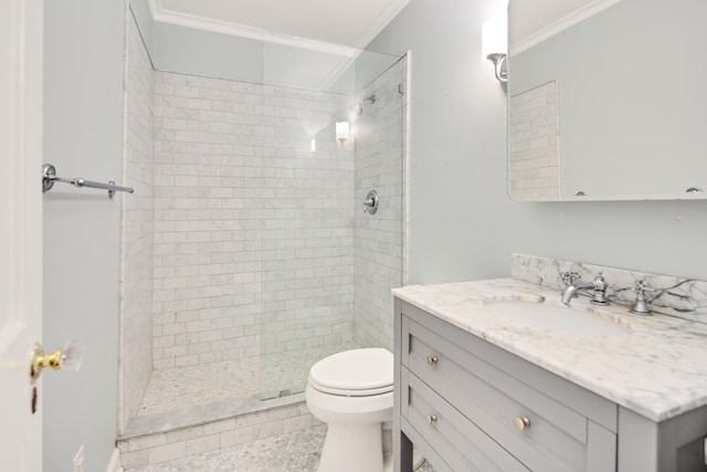 full bath with toilet, a tile shower, vanity, and crown molding