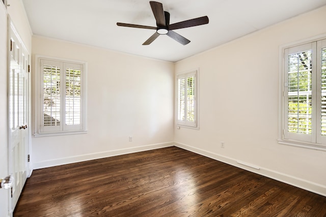 unfurnished room with a ceiling fan, baseboards, dark wood-type flooring, and crown molding