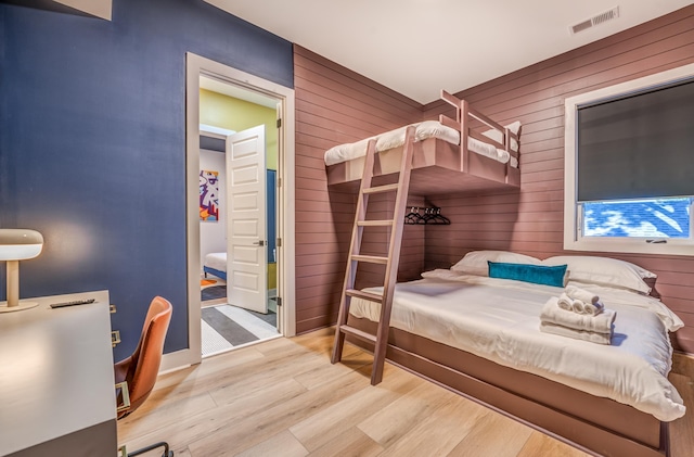 2283 Young Ave, Memphis, TN 38104 - bedroom with wood finished floors, wooden walls, and visible vents
