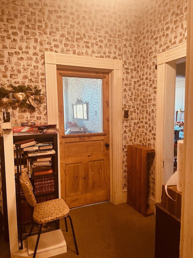 doorway to outside with wallpapered walls