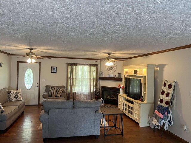 living area with ornamental molding, a ceiling fan, and dark wood-type flooring