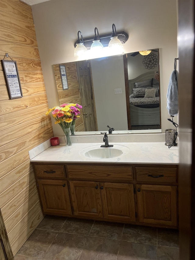 bathroom featuring stone finish flooring and vanity