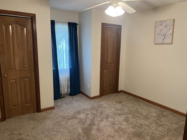 unfurnished bedroom with baseboards and carpet