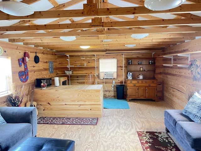 living area with lofted ceiling with beams and wood walls