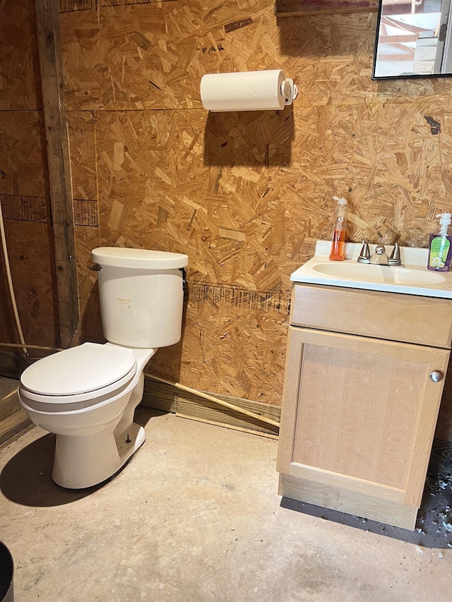 half bathroom with toilet and vanity