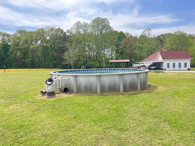 outdoor pool featuring a lawn