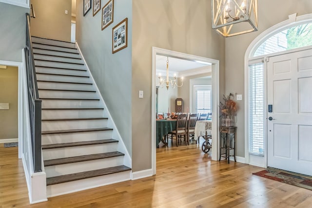 10290 W Shrewsbury Run, Collierville, TN 38017 - entrance foyer featuring stairway, wood finished floors, a chandelier, and plenty of natural light