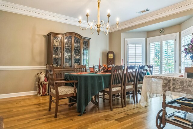 10290 W Shrewsbury Run, Collierville, TN 38017 - dining space with baseboards, visible vents, a notable chandelier, wood finished floors, and ornamental molding
