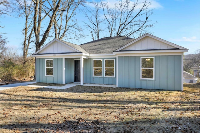 ranch-style house featuring board and batten siding and a shingled roof