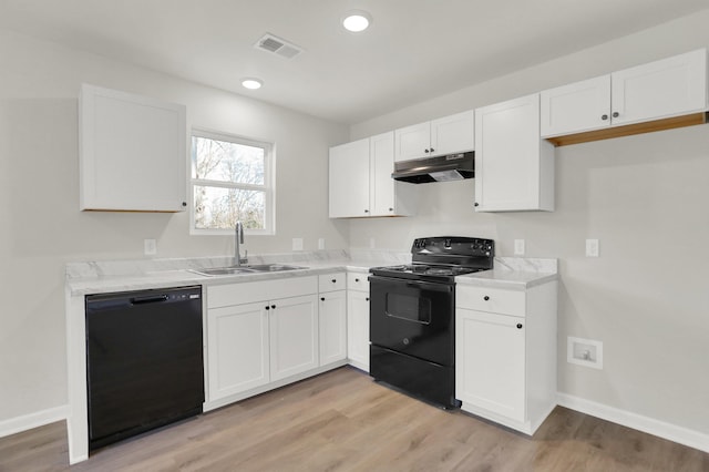 kitchen with under cabinet range hood, a sink, white cabinetry, and black appliances