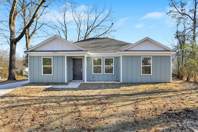 ranch-style home featuring board and batten siding and a shingled roof