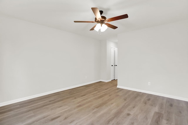 unfurnished room with ceiling fan, baseboards, and light wood-style flooring