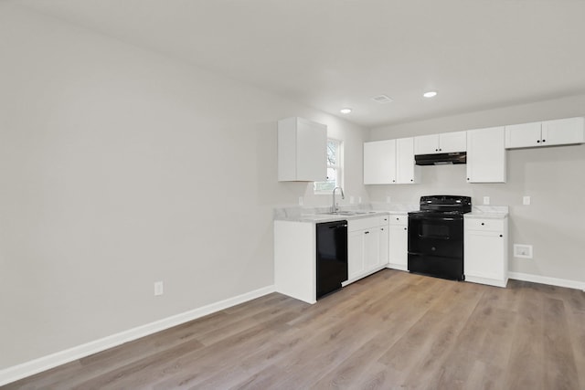 kitchen featuring a sink, baseboards, light countertops, under cabinet range hood, and black appliances
