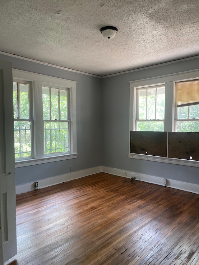 spare room featuring hardwood / wood-style floors and a textured ceiling