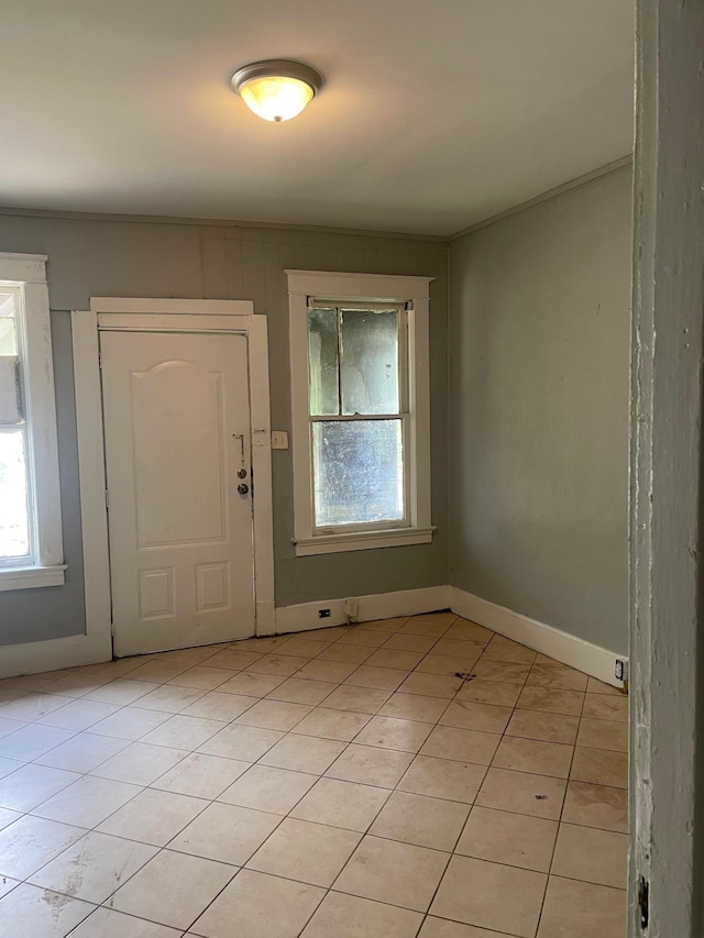 interior space featuring baseboards and light tile patterned floors