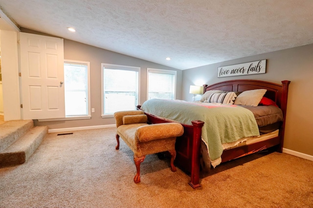 bedroom featuring baseboards, vaulted ceiling, visible vents, and carpet flooring