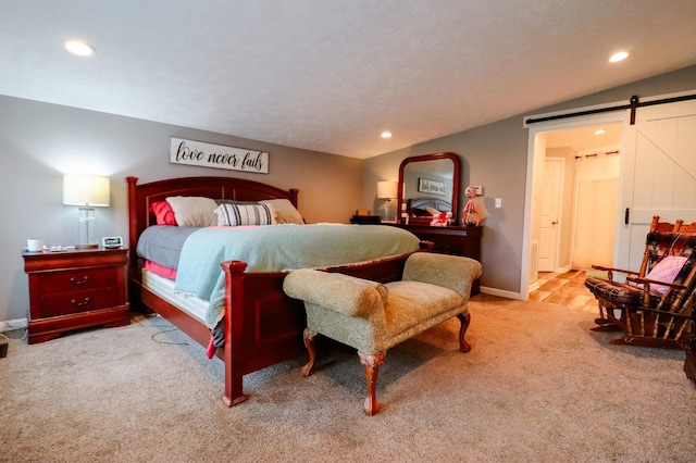 bedroom with carpet, recessed lighting, and a barn door
