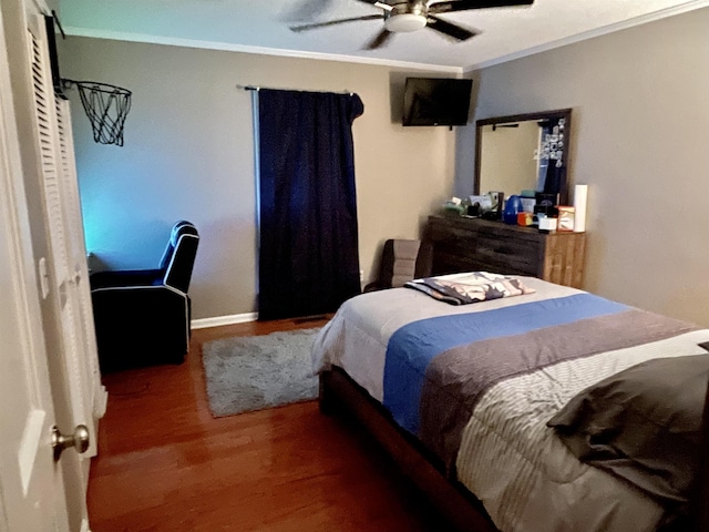 bedroom featuring a ceiling fan, baseboards, crown molding, and wood finished floors