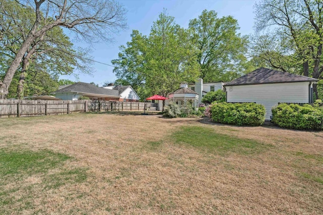 view of yard featuring fence and a gazebo