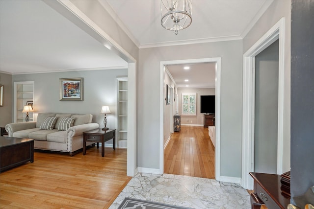 entryway featuring baseboards, recessed lighting, a notable chandelier, light wood-style floors, and crown molding