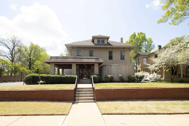 traditional style home with a front lawn and covered porch