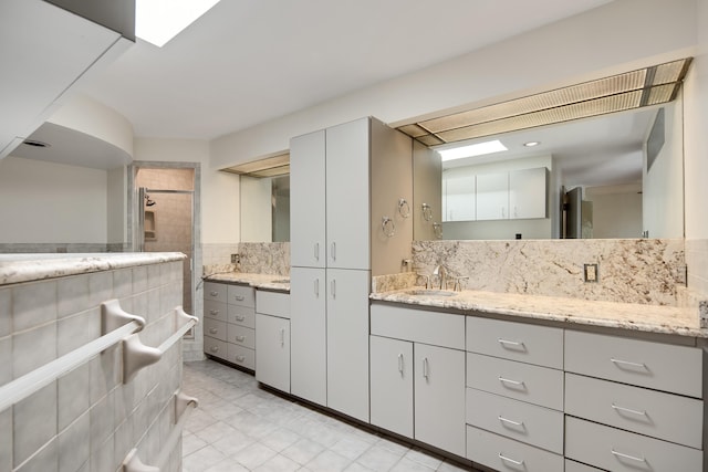 bathroom featuring walk in shower, tile walls, vanity, and tile patterned floors