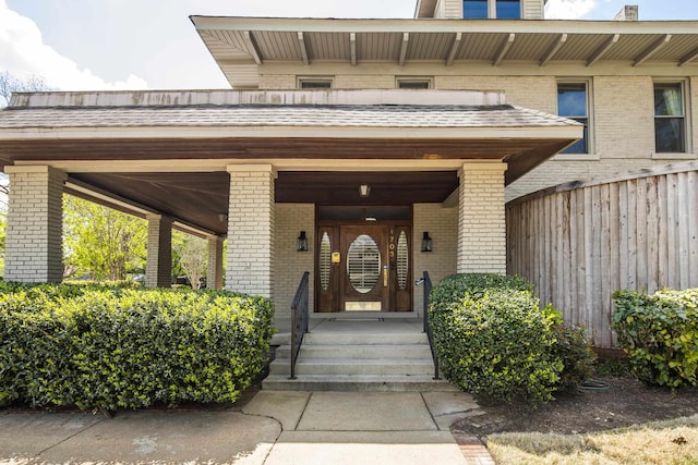 doorway to property with brick siding