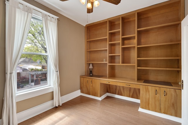 unfurnished office with light wood-type flooring, baseboards, and ceiling fan