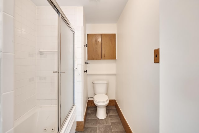 full bathroom featuring combined bath / shower with glass door, baseboards, and toilet