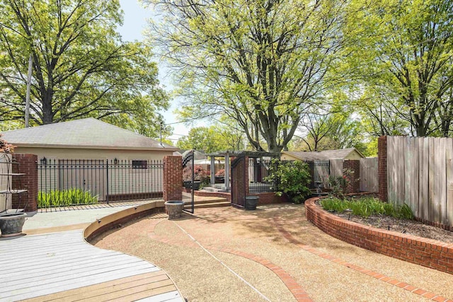 view of yard featuring a fenced backyard, a wooden deck, and a patio