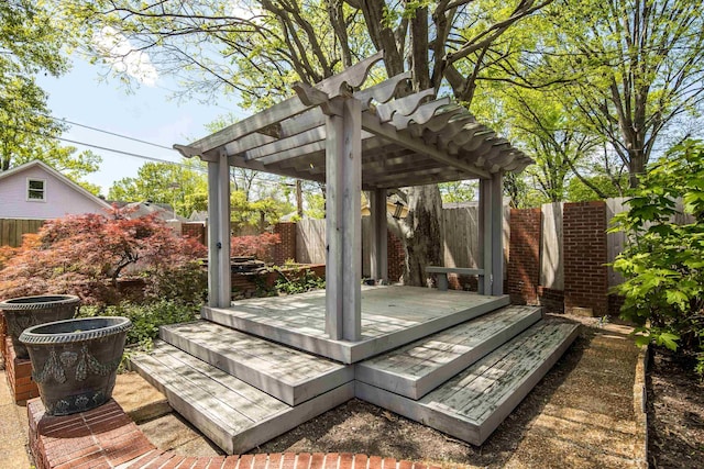 deck featuring a pergola and a fenced backyard