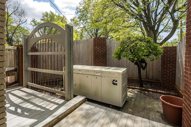 wooden terrace with a gate and fence