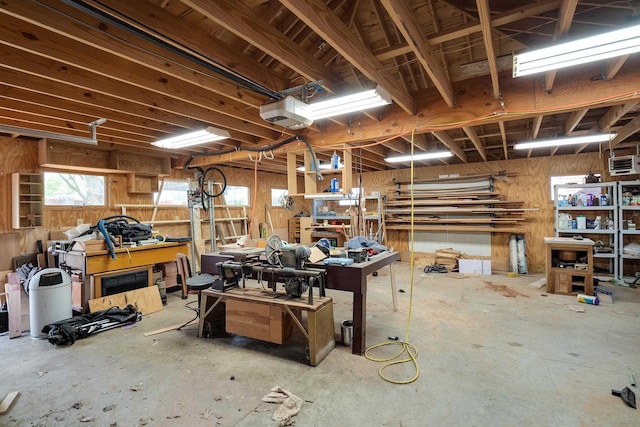misc room featuring a workshop area and wooden walls
