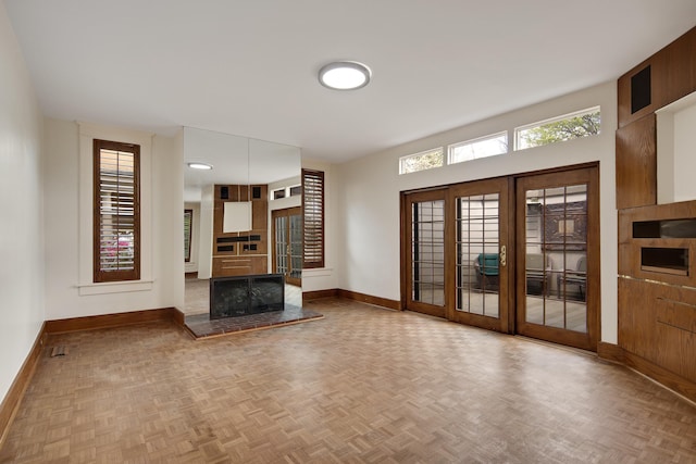 unfurnished living room featuring baseboards