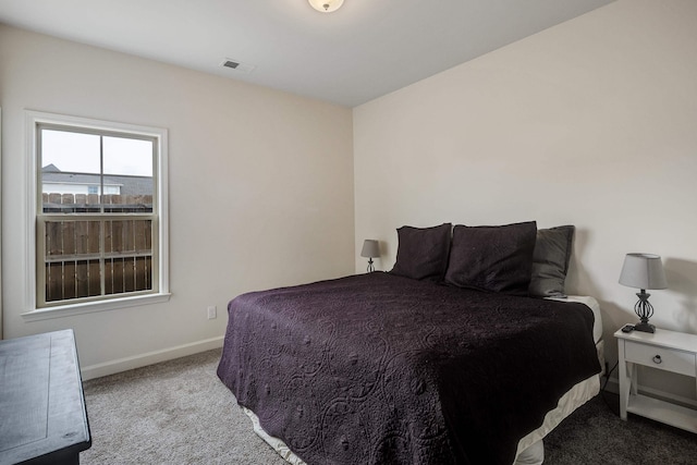 carpeted bedroom featuring baseboards and visible vents
