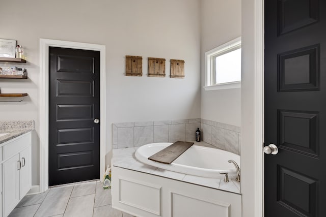 bathroom featuring vanity, a garden tub, and tile patterned flooring