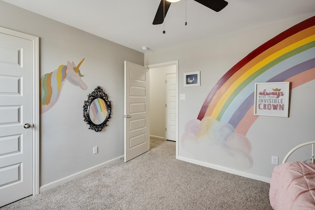carpeted bedroom featuring a ceiling fan and baseboards