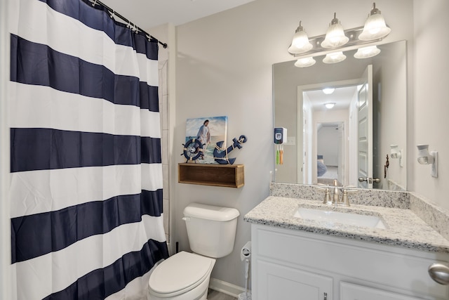 bathroom with vanity, curtained shower, and toilet